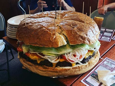 Food challenges - The challenge is on – If you can eat this gargantuan burger (6 Franky’s beef burger patties stacked on a sesame bun with cheese, jalapeno peppers, bacon, lettuce, tomato, fried onions, dill pickles, mayo, fries, onion rings and coleslaw) in 10 minutes or less you get it for FREE. You also get your name inscribed on our wall of fame and a T ...